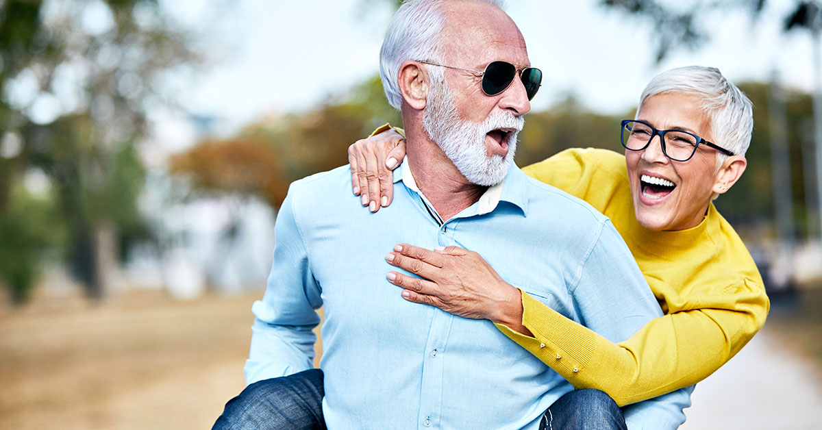Happy senior elderly couple smiling in embrace