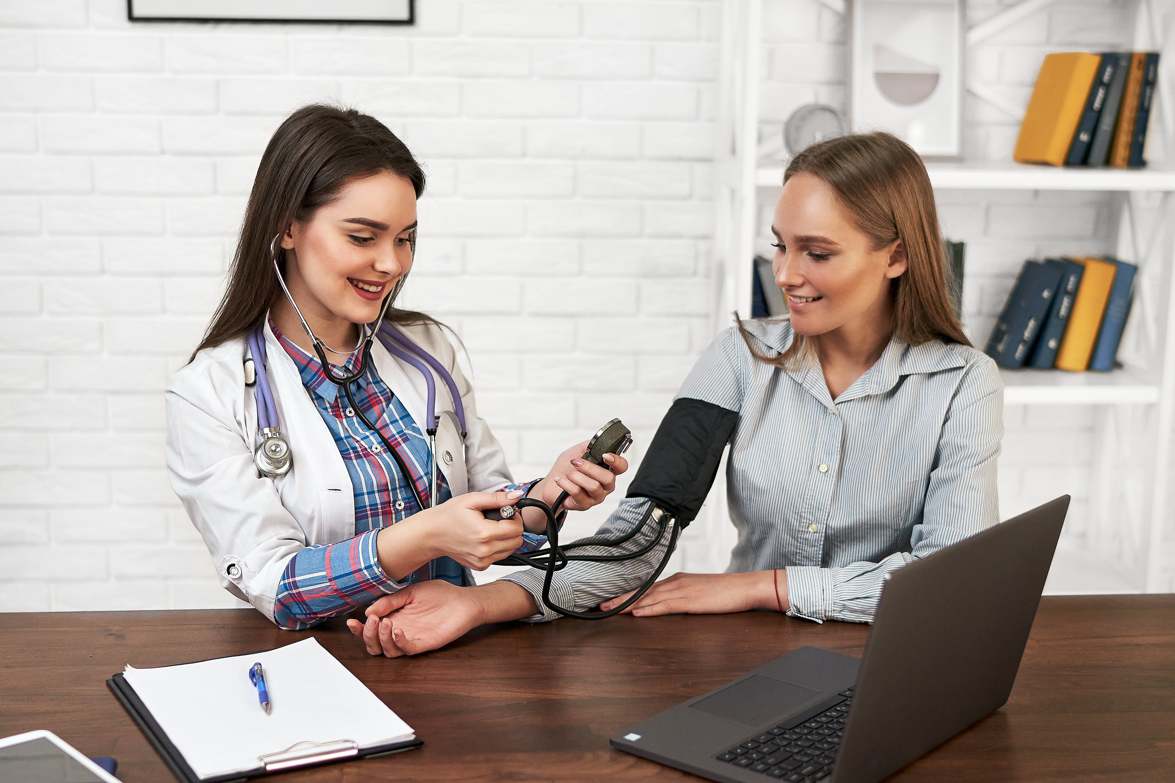 beautiful-woman-family-doctor-measures-blood-pressure-with-tonometer