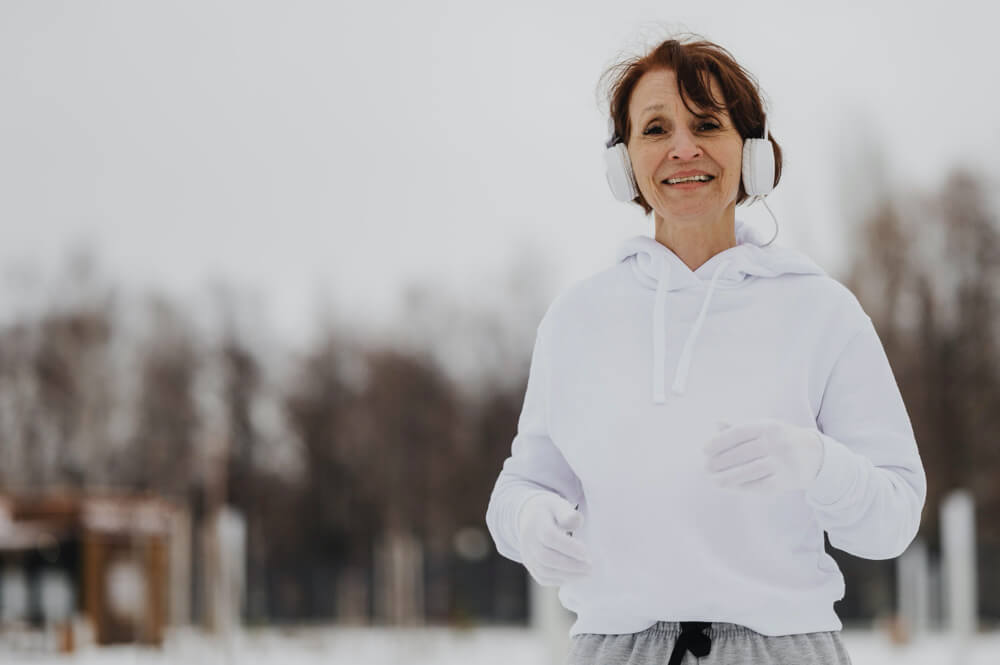 Medium shot woman running with headphones